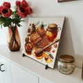 Decorative tile with honey theme on a kitchen counter with flowers and jars.