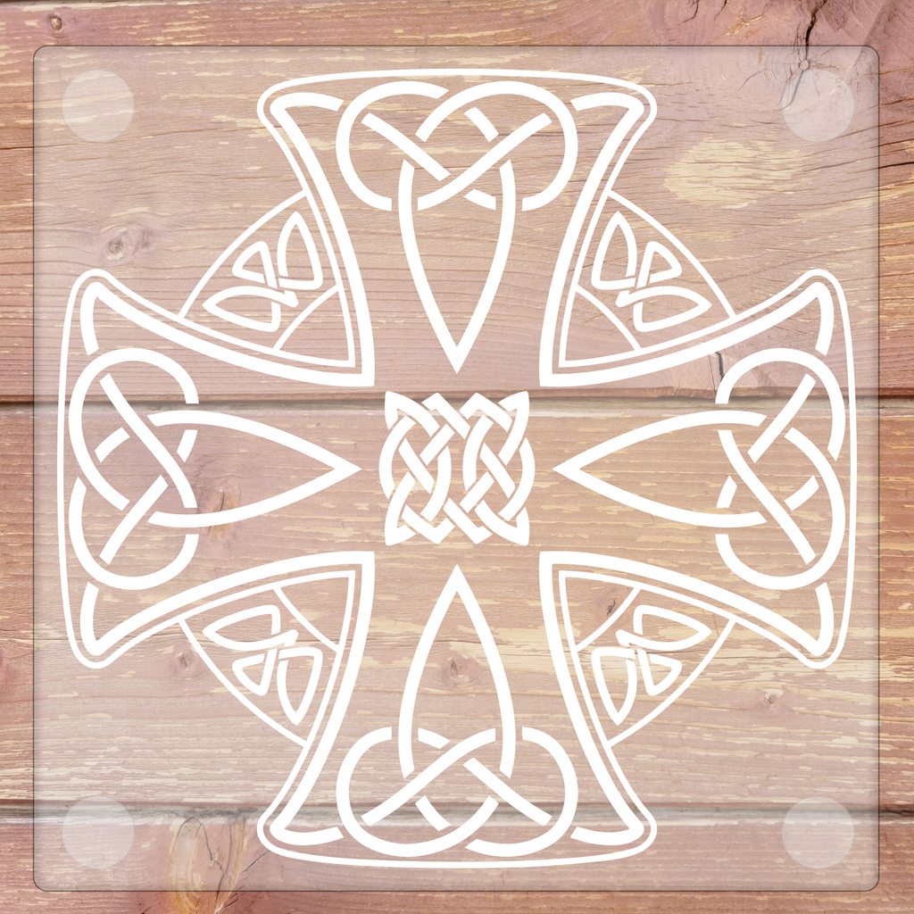 Glass coaster with a decorative white cross with intricate patterns on a wooden background