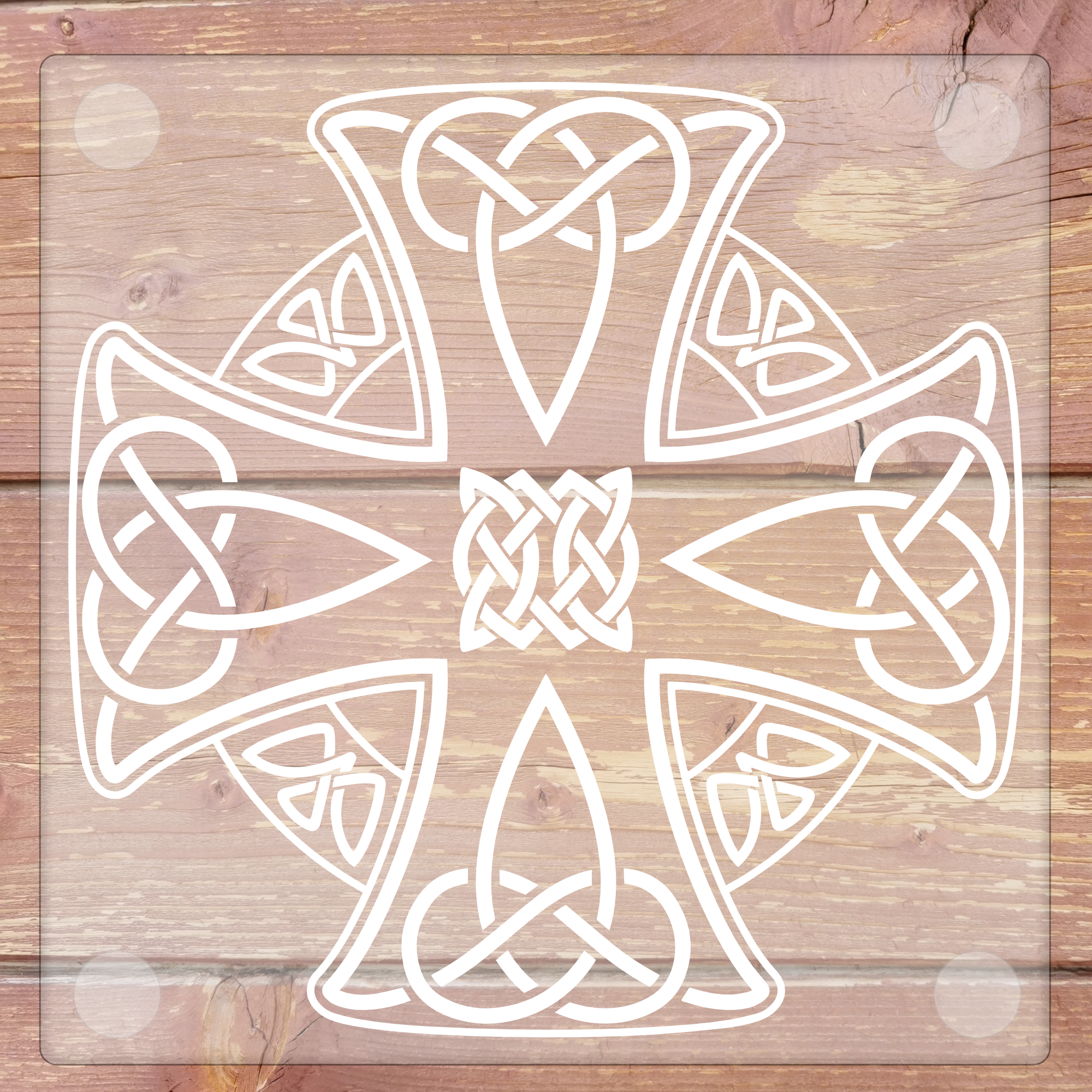 Glass coaster with a decorative white cross with intricate patterns on a wooden background