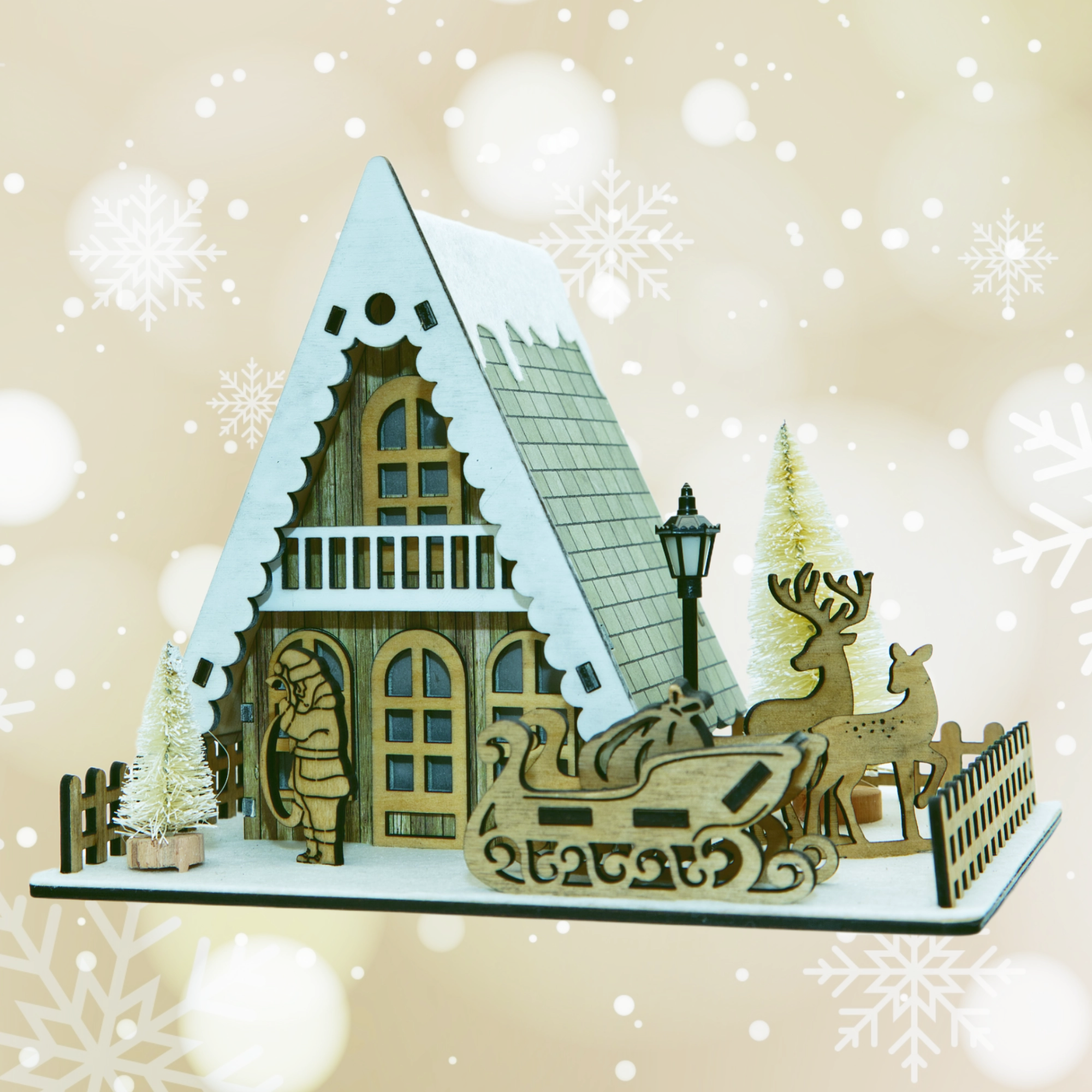 Wooden Christmas scene with house, reindeer, and sleigh on a beige background with snowflakes.