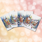 Set of Christmas-themed coasters with a village scene on a blurred bokeh background.