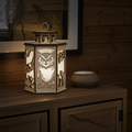 Wooden lantern with owl design on a wooden surface