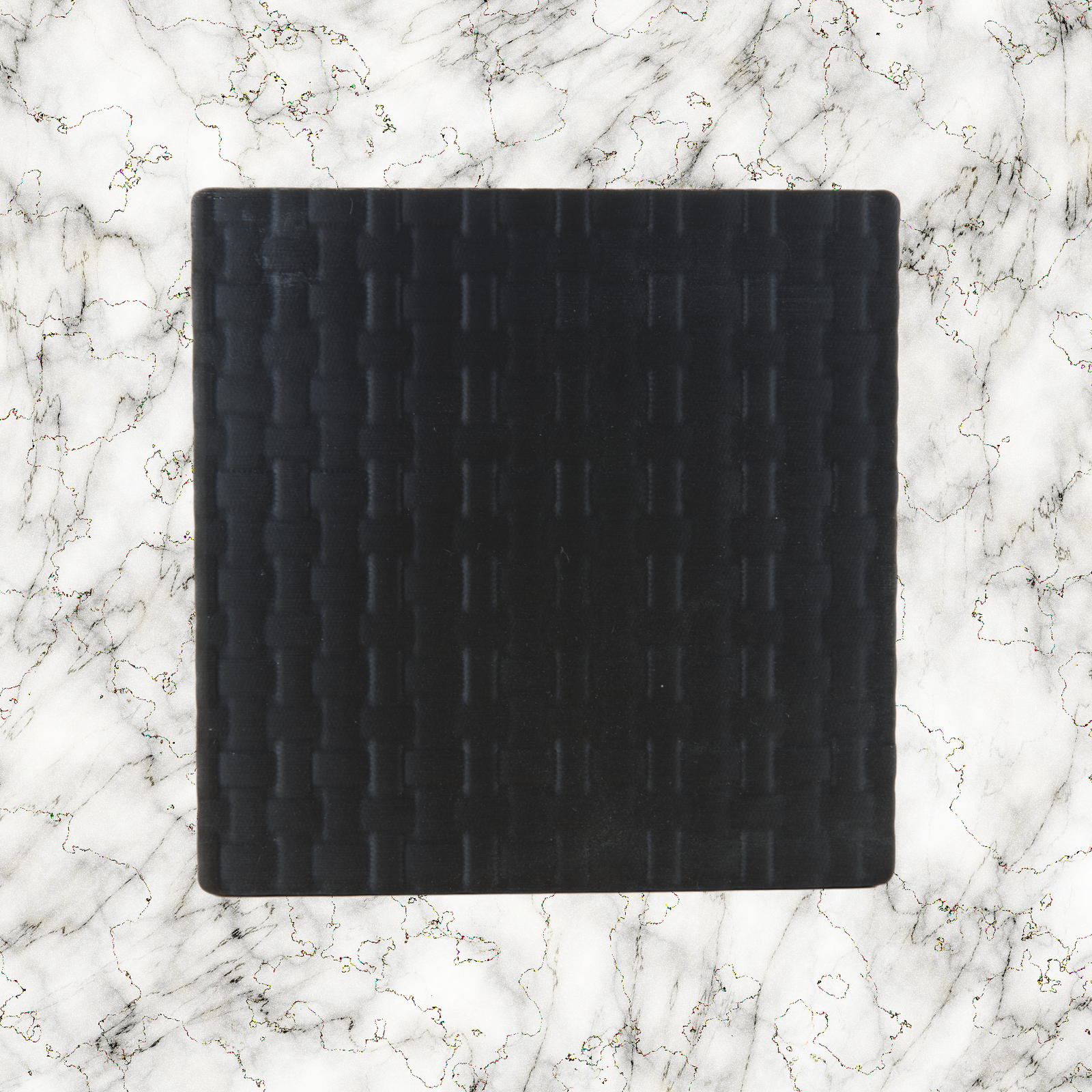 Black weave textured lightbox lid on a marble background