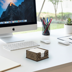 Modern office desk with computer, stationery, and a wooden 'Notes' holder.