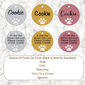 Dog tags with cutout paw print on a marble background