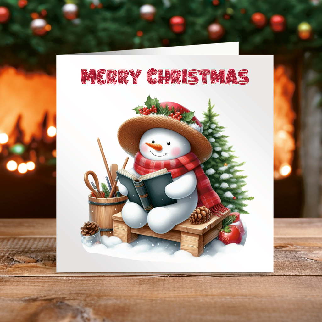 Christmas card with a snowman reading a book, surrounded by Christmas decorations.