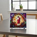 Decorative trivet with stained glass design of a religious figure on a table.