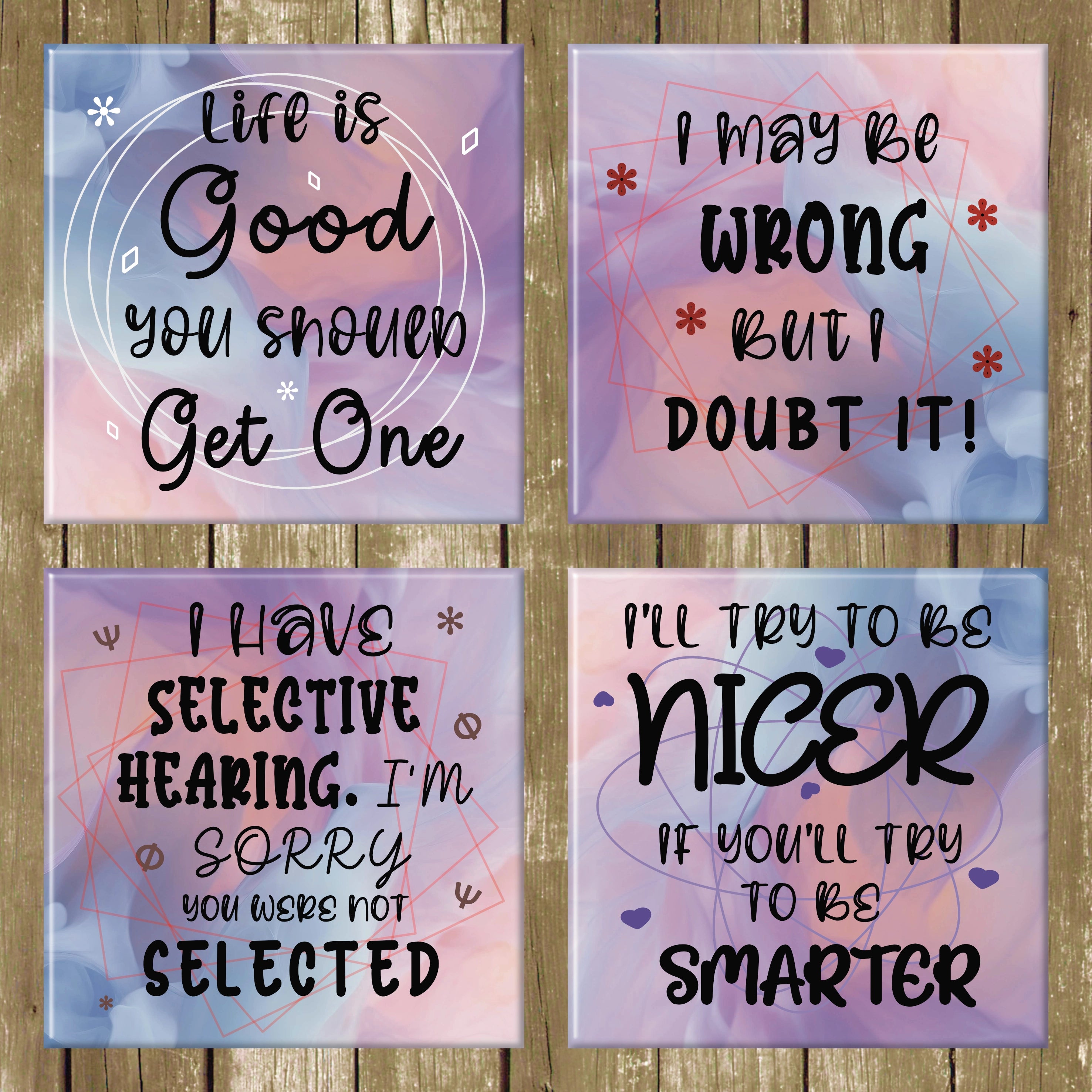 Four motivational coasters with humorous quotes on a wooden background