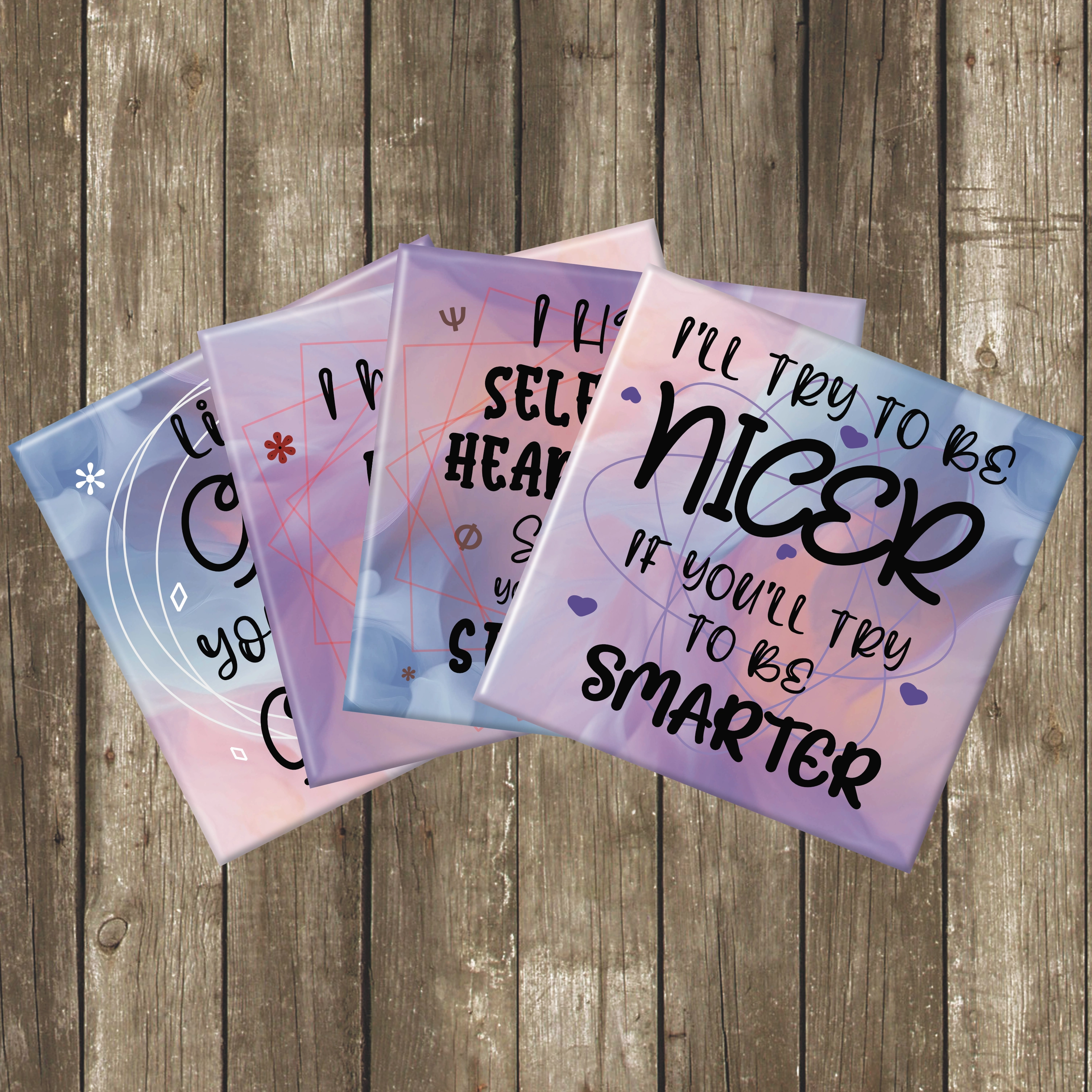 Four coasters with different sarcastic messages on a woodenbackground.