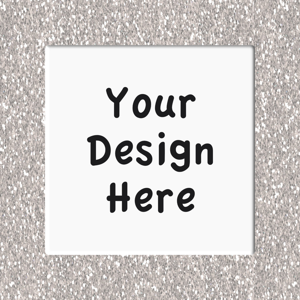 Placeholder design with 'Your Design Here' text on a white square coaster against a silver glittery background