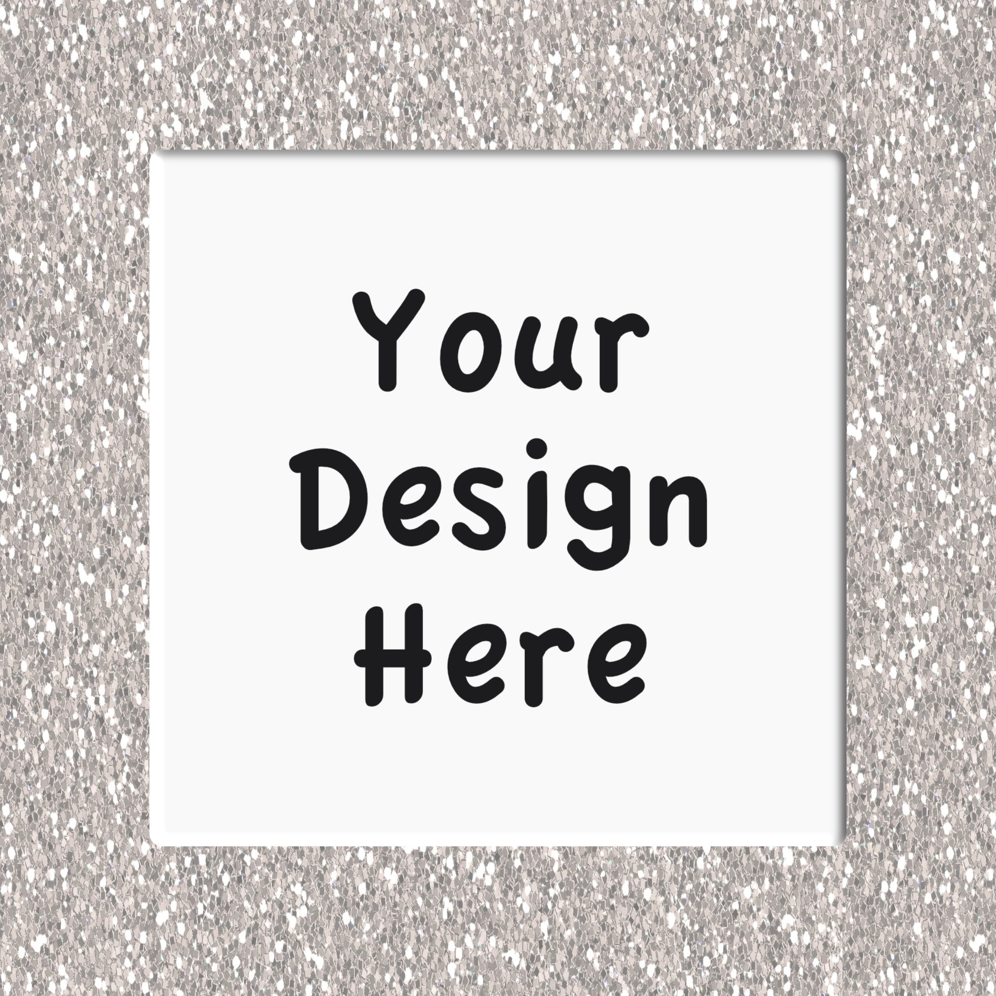Placeholder design with 'Your Design Here' text on a white square coaster against a silver glittery background