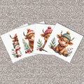Four Christmas-themed coasters with cartoon Highland cows wearing hats on a glittery silver background.